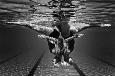 Underwater view of synchronized swimming duetの写真素材