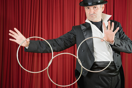 Stage magician performing classic trick with ringsの写真素材