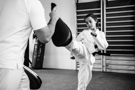 Taekwondo instructor working with little girlの写真素材