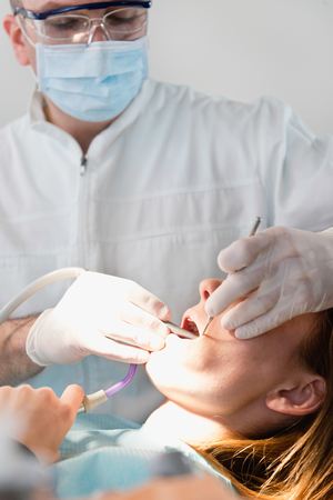 Dentist working with patientの写真素材