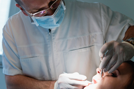 Dentist working with patientの写真素材