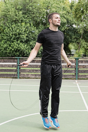 Male athlete jumping rope outdoorsの写真素材