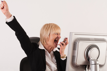 Business woman sharing good results over the phoneの写真素材
