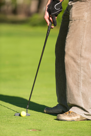 Golfer putting, selective focusの写真素材