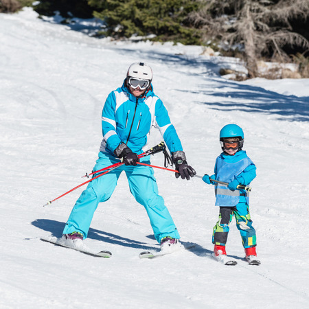 Ski instructor working with little boyの写真素材