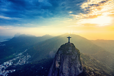 Corcovado mountain in Rio De Janeiro. Statue of Christ overlooking the city at sunsetの写真素材