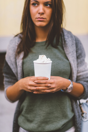 Woman with take-away coffee in the cityの写真素材