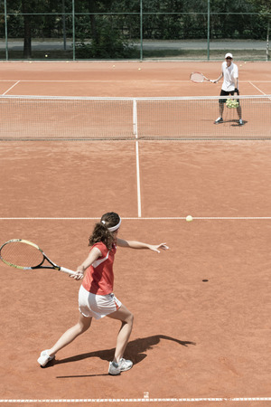 Junior female on tennis classの写真素材