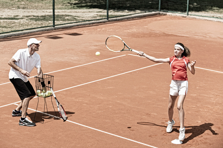 Teenage female player on tennis class outdoorsの写真素材
