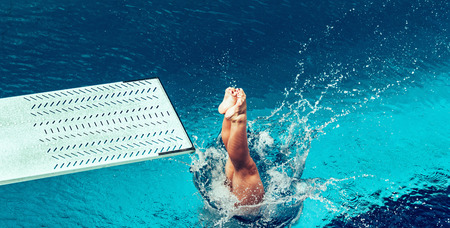 Female diver jumping from platform, high angle viewの写真素材
