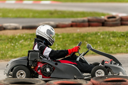 Woman driving go-cart on a sports trackの写真素材
