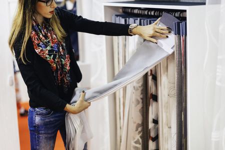 Designer choosing fabric for curtainsの写真素材