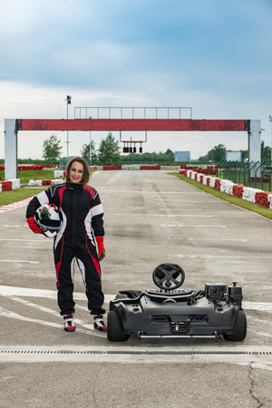 Woman driving go-cart on a sports trackの写真素材