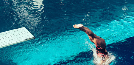 Female diver jumping from platform, high angle viewの写真素材