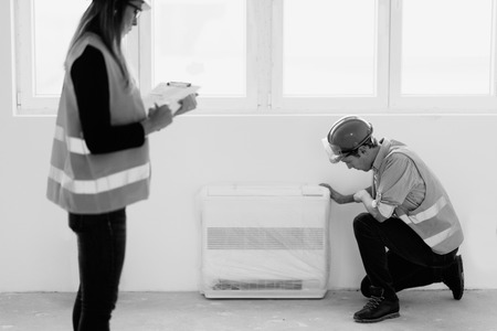 Maintenance Engineer checking air conditionerの写真素材