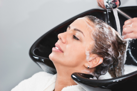 Hair washing by hairdresser in beauty salonの写真素材