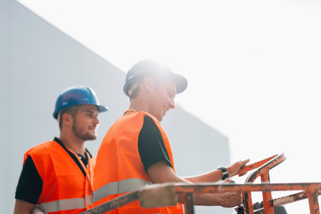 Construction workers operating  on construction machine