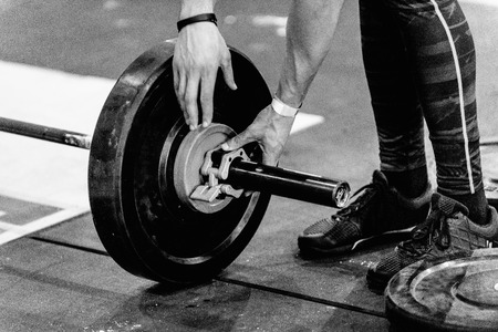 Changing weights on crossfit competitionの写真素材