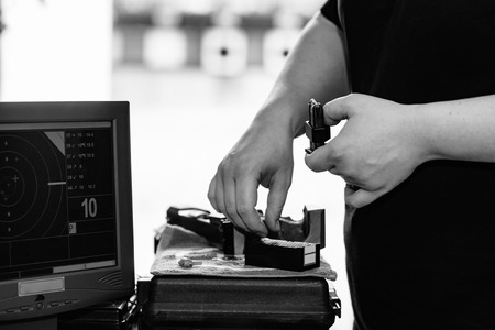 Woman pulling pistol on sport shooting trainingの写真素材