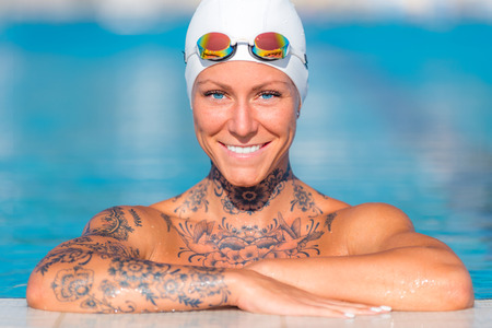 Poolside portrait of female with tattoosの写真素材