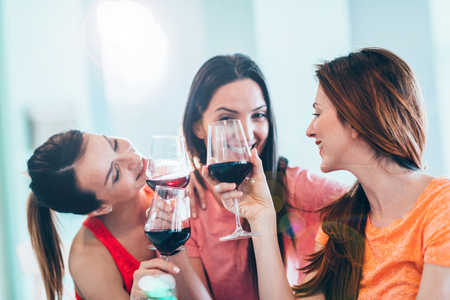 Friends drinking wine in restaurantの写真素材