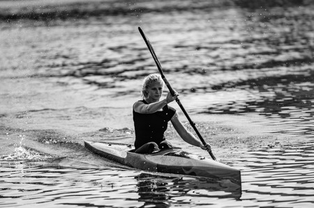 Female Kayaker training on lakeの写真素材