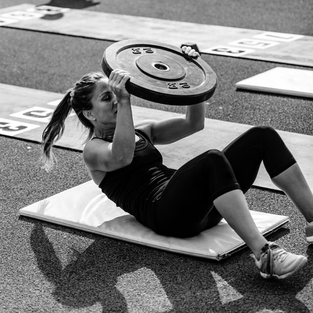 Woman with weights on cross competitionの写真素材