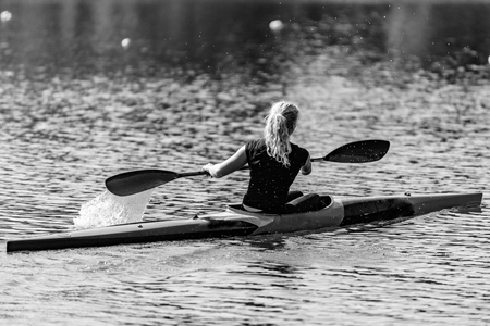 Female Kayaker training on lakeの写真素材