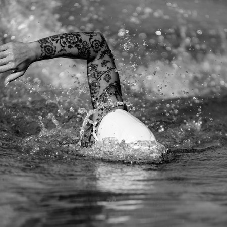 Female front crawl swimmer with tattoos  during trainingの写真素材