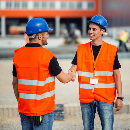 Construction workers handshaking after meeting on construction siteの写真素材