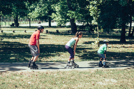 Family roller skating in a raw
