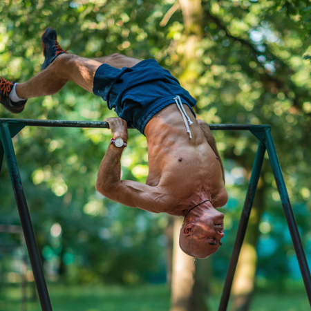 Senior male exercising outdoors in public parkの写真素材