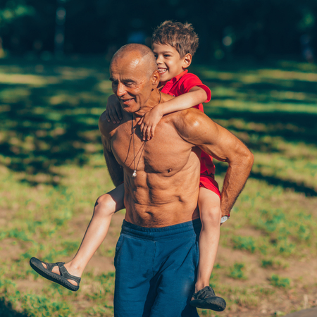 Grandfather and grandson  exercising in parkの写真素材