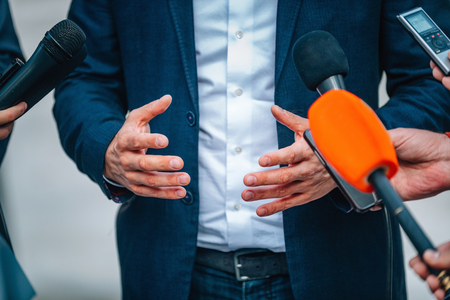 Interviewing businessman on press conferenceの写真素材