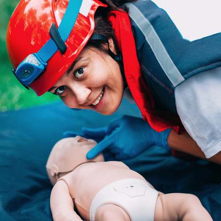 Cpr training on baby dummy outdoorsの写真素材