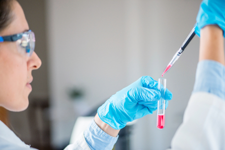 Laboratory technician with micro pipette