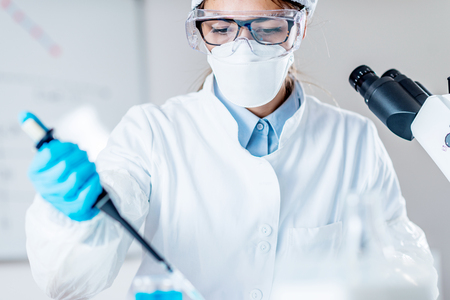 Life science research. Technician using micro pipetteの写真素材
