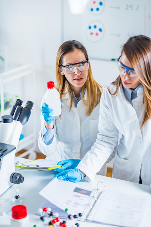 Biotechnology scientists taking notesの写真素材
