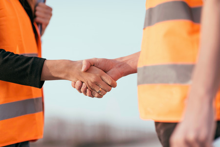 Architects handhaking after successful meeting on construction site