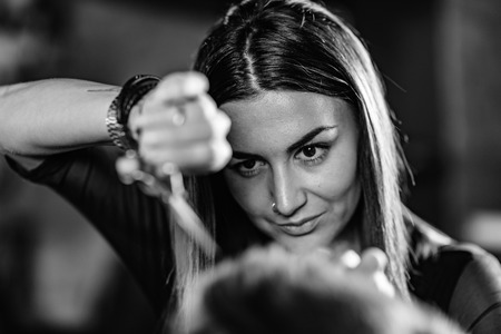 Hair styling man in hairsalon by female hairdresserの写真素材