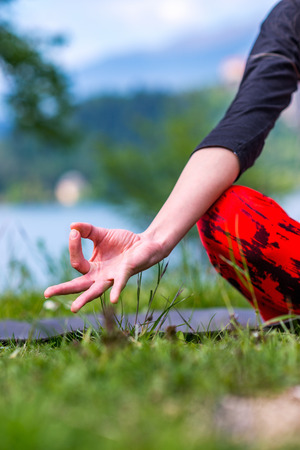 Woman doing yoga by the lakeの写真素材