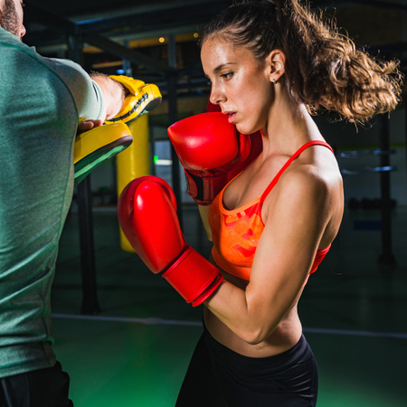 Female on boxing class with her male instructorの写真素材