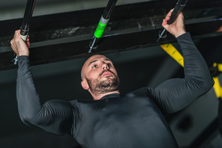 Man doing pull-ups in the gym