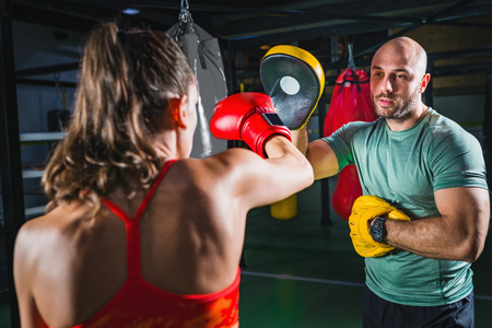 Female on boxing class with her male instructorの写真素材