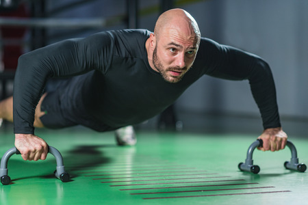 Man doing push-ups in the gymの写真素材