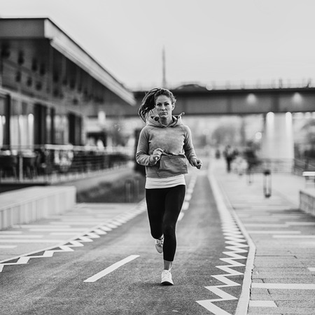Woman jogging on riversideの写真素材