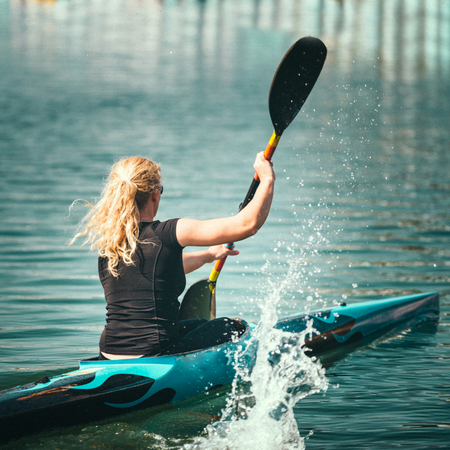 Female kayaker training on lakeの写真素材