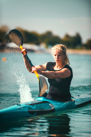 Female kayaker training on lakeの写真素材