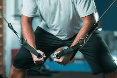 Peronal trainer with male client exercising in the gymの写真素材