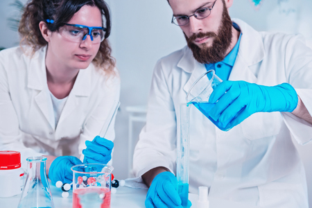 Young Scientist Doing Experiments In The Laboratory, Wearing Safety Equipmentの写真素材